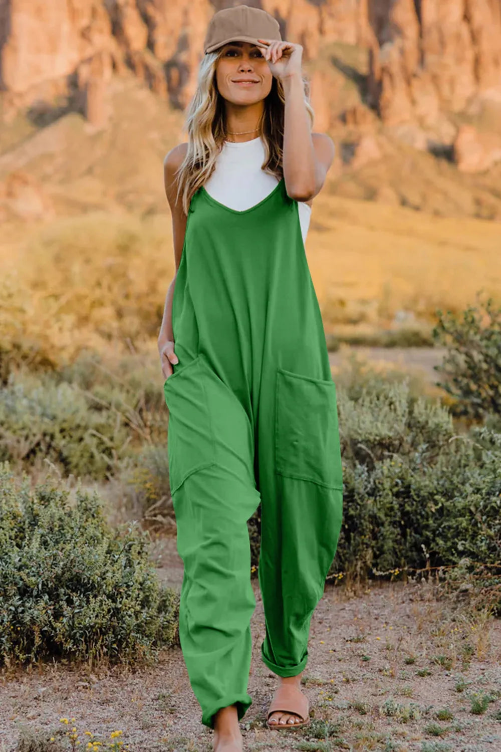 Green V-neck wide-leg jumpsuit with pockets and a comfortable cotton feel.