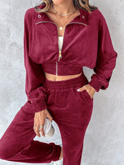Burgundy velvet crop tracksuit with zipper detail and cinched waist.
