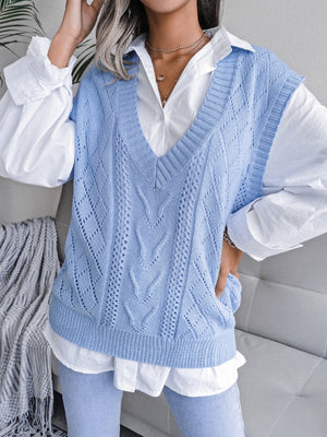 Light blue openwork cable knit vest with V-neck and diamond pattern detail.
