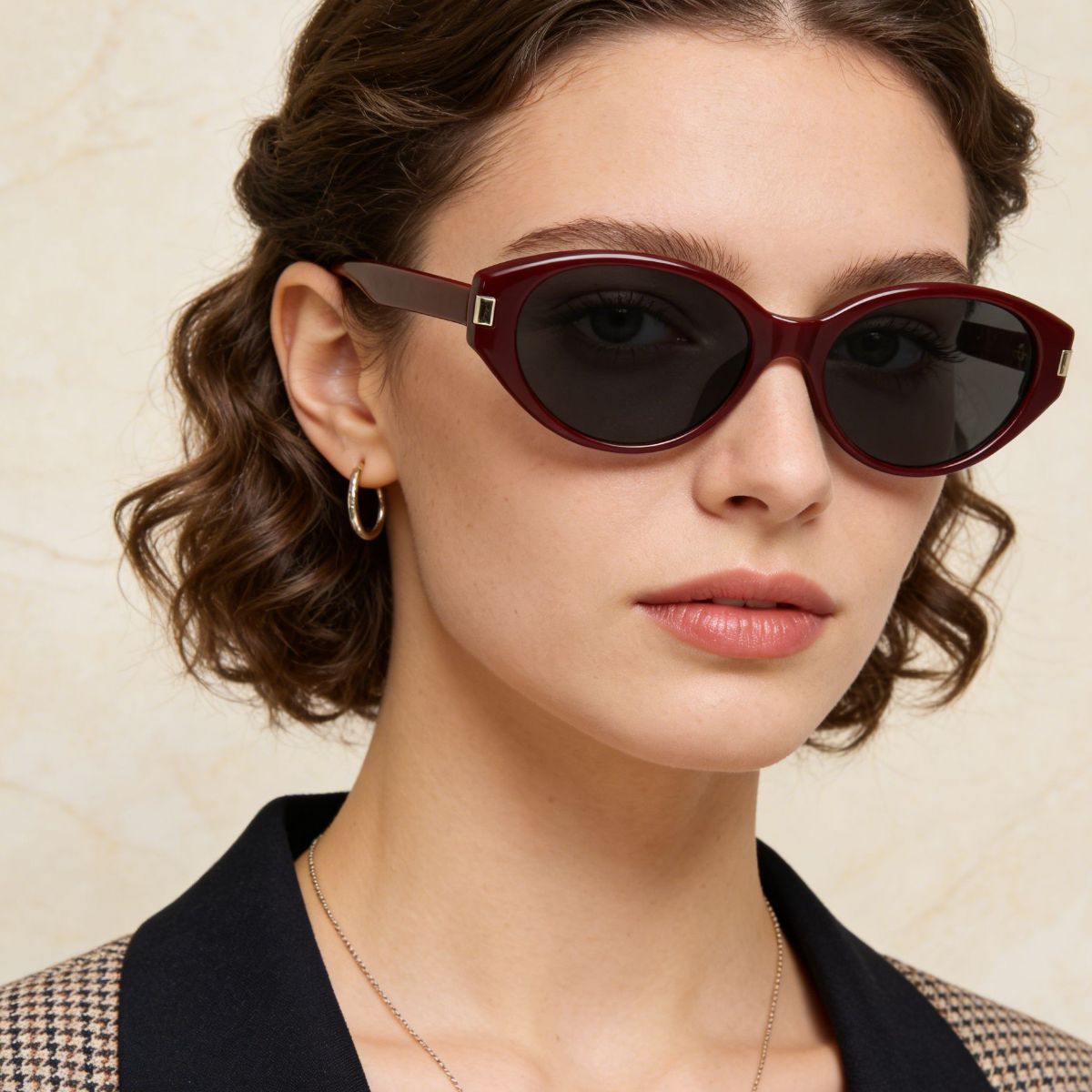 Burgundy cat-eye sunglasses with dark lenses and gold accents.