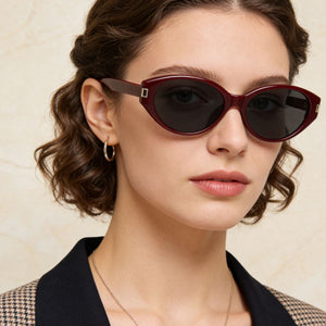 Burgundy cat-eye sunglasses with dark lenses and gold accents.
