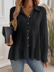 Black textured tiered button-down shirt with crinkled fabric and button details.
