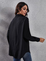 Black button-down shirt with long sleeves and a collared neckline.