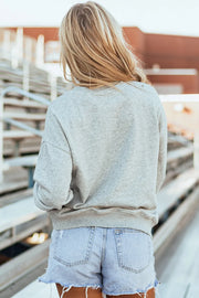 Gray sweatshirt with baseball stitch bow graphic detail on back.