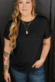 Black crewneck cotton t-shirt with cuffed sleeves and layered necklaces.