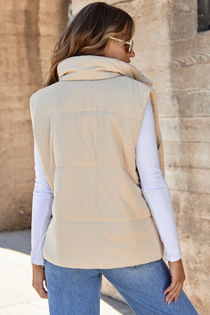 Tan corduroy padded funnel neck vest with horizontal quilting detail.