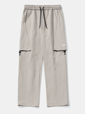 Gray cargo pants with drawstring waist and black trim pockets.