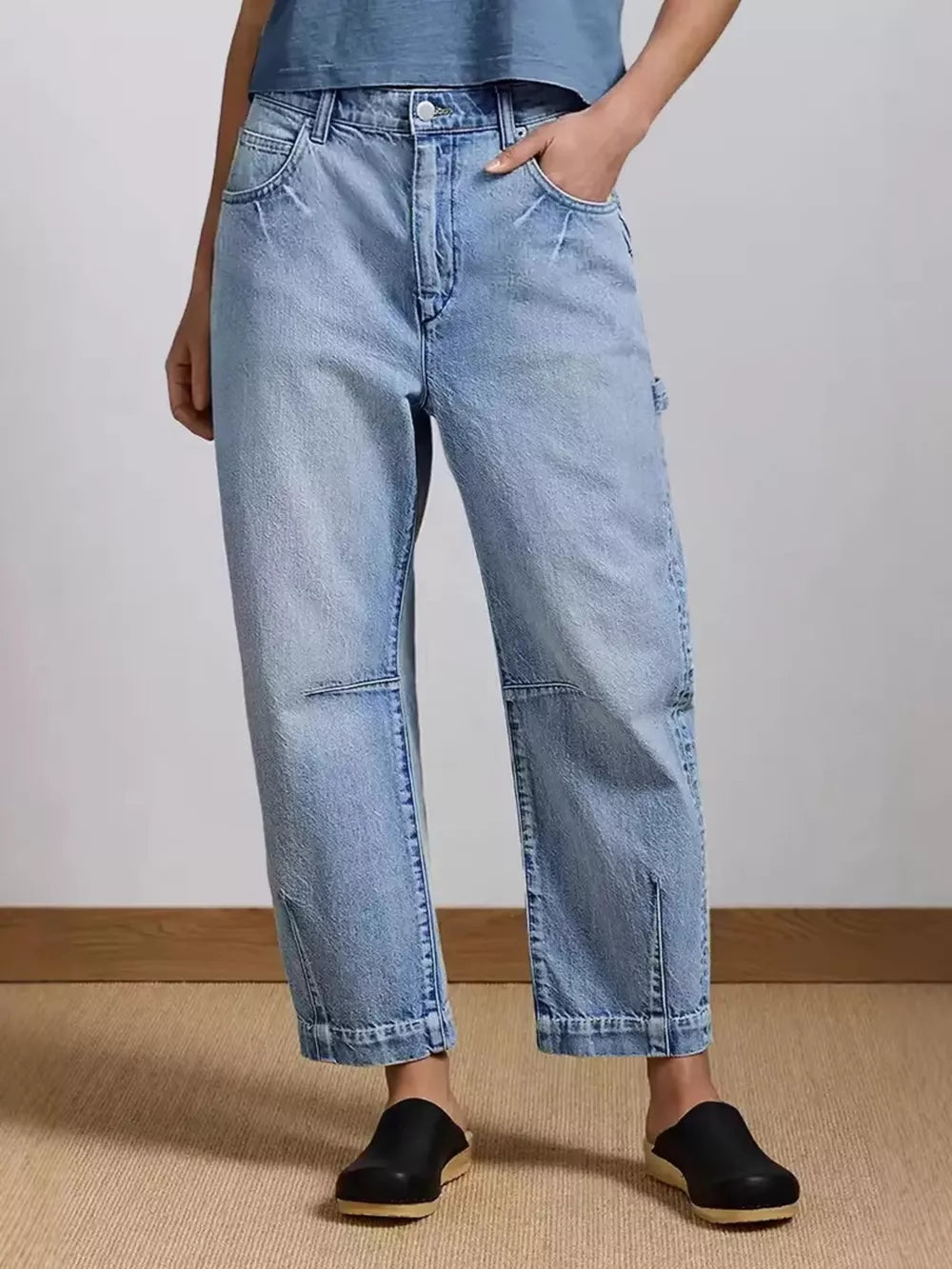 Light wash denim maternity jeans with a wide-leg cut and buttoned front.