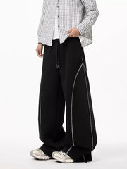 Black wide-leg drawstring sweatpants with contrast stitching detail.