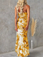 Yellow floral one-shoulder maxi dress with ruched detailing and asymmetrical neckline.