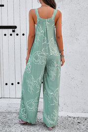 Light green abstract scribble wide leg jumpsuit with pleats and wide straps.