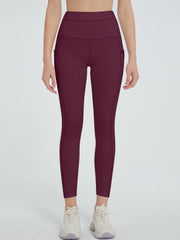 Burgundy pocketed sculpt leggings with a high waist.