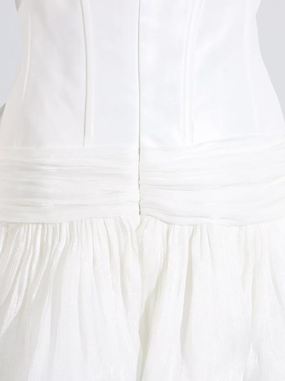 White mini dress with ruched bodice and tiered ruffled skirt.