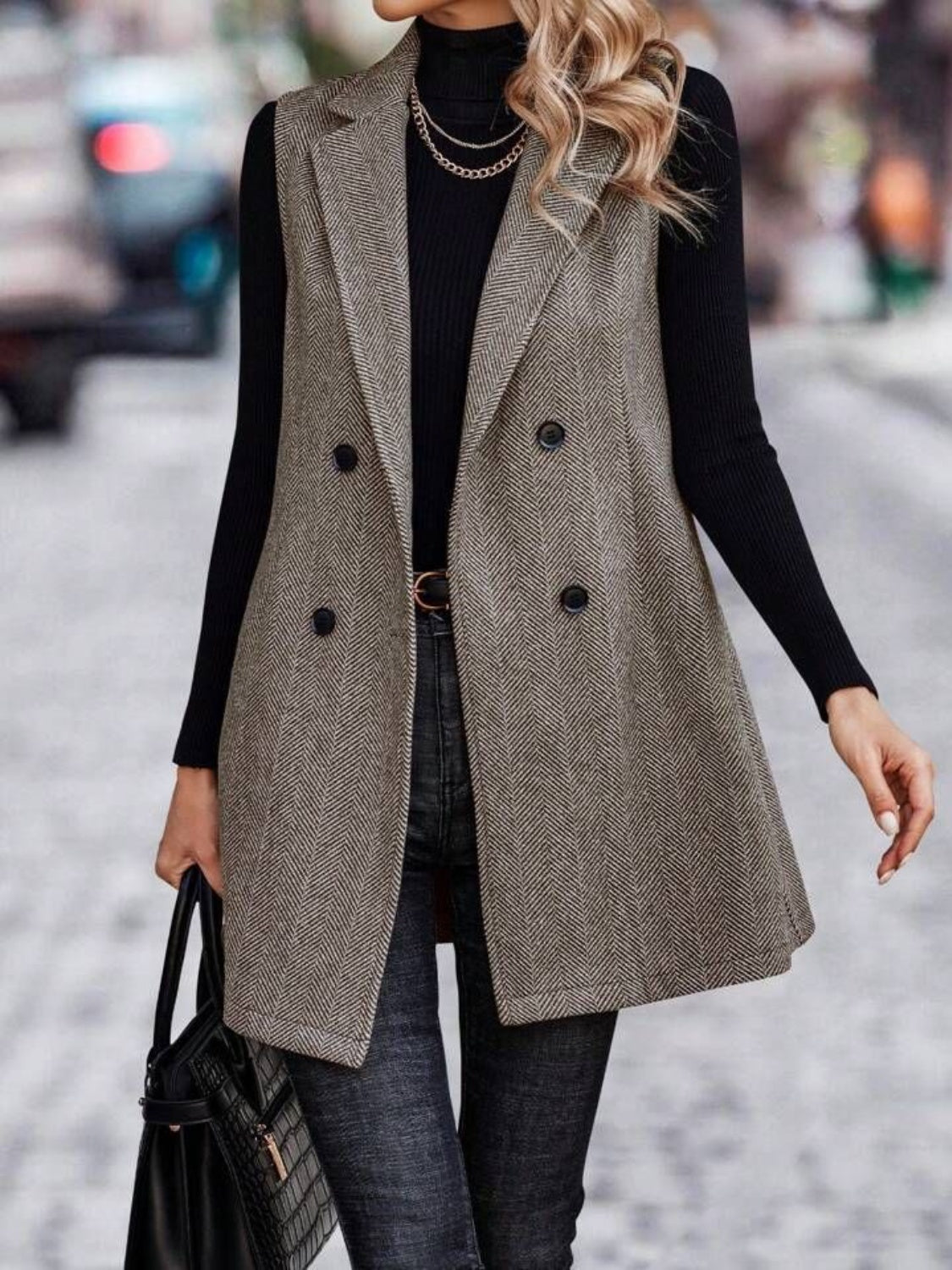 Herringbone double-breasted tailored vest in taupe with a collared neckline and buttoned front.