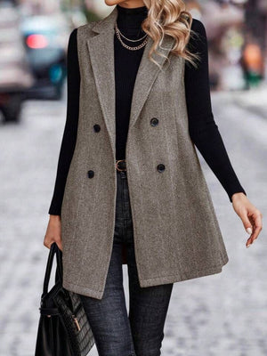 Herringbone double-breasted tailored vest in taupe with a collared neckline and buttoned front.
