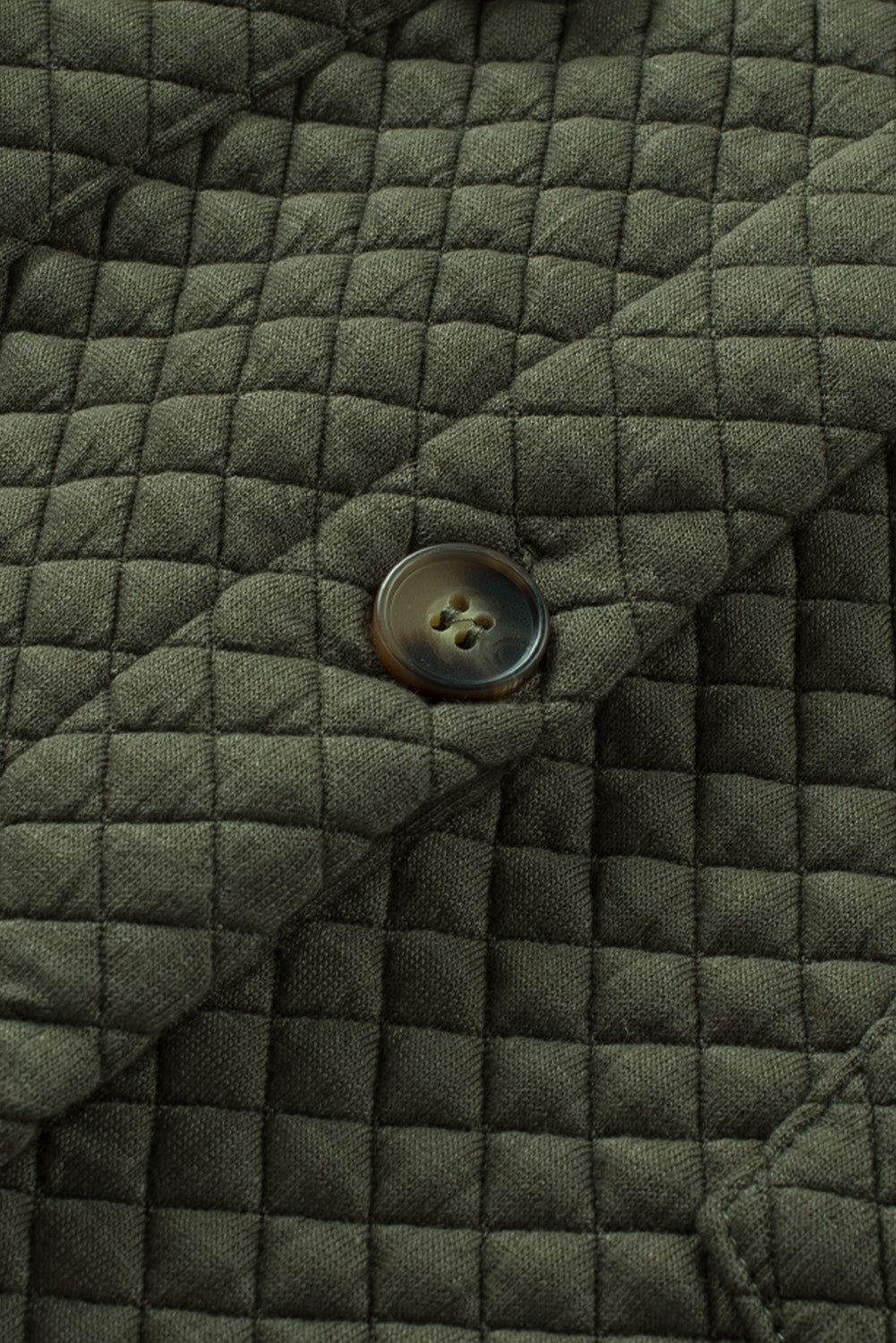 Army green quilted overshirt with button detail and patch pocket flap.