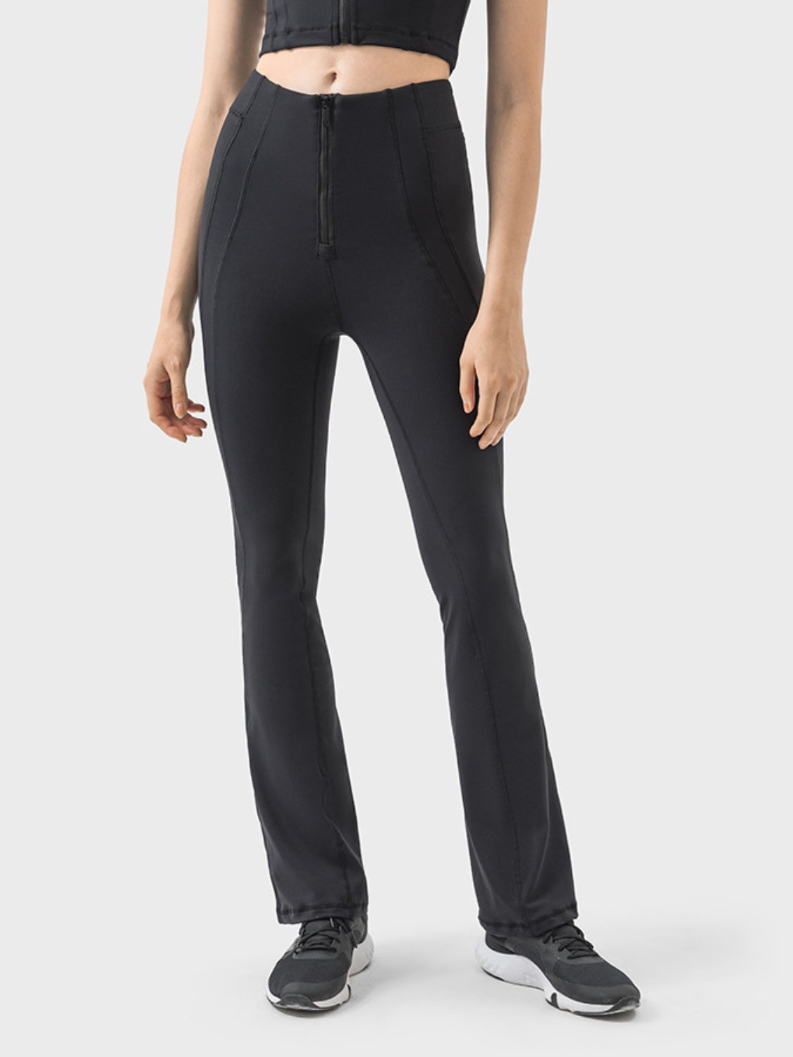 Black activewear pants with a front zipper and flared leg