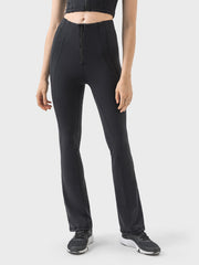 Black activewear pants with a front zipper and flared leg