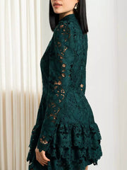 Dark green lace mock neck mini dress with tiered ruffle hem and long sleeves.