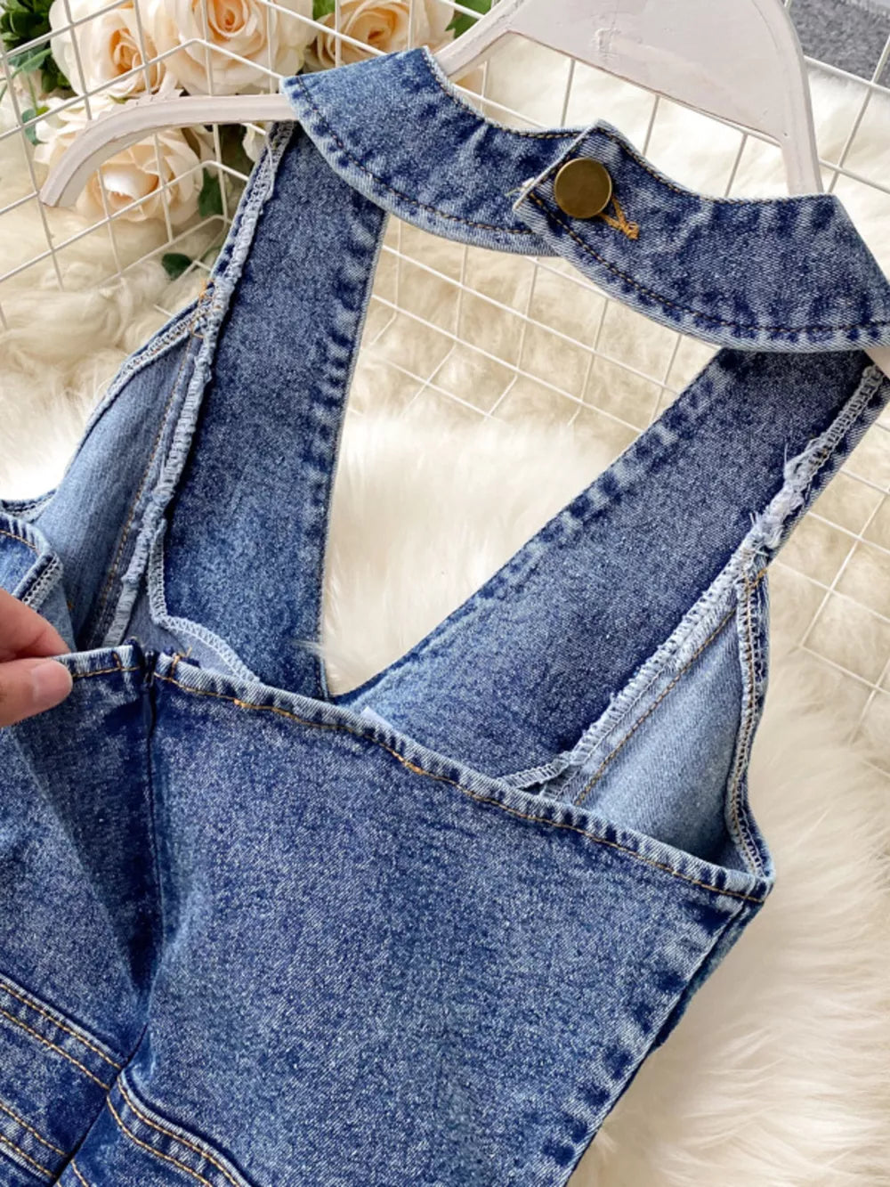 Blue denim halter neck wide-leg jumpsuit with button detail at collar