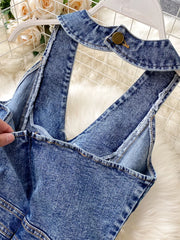Blue denim halter neck wide-leg jumpsuit with button detail at collar