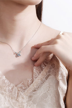 Silver bow-tie diamond pendant necklace with a delicate chain.