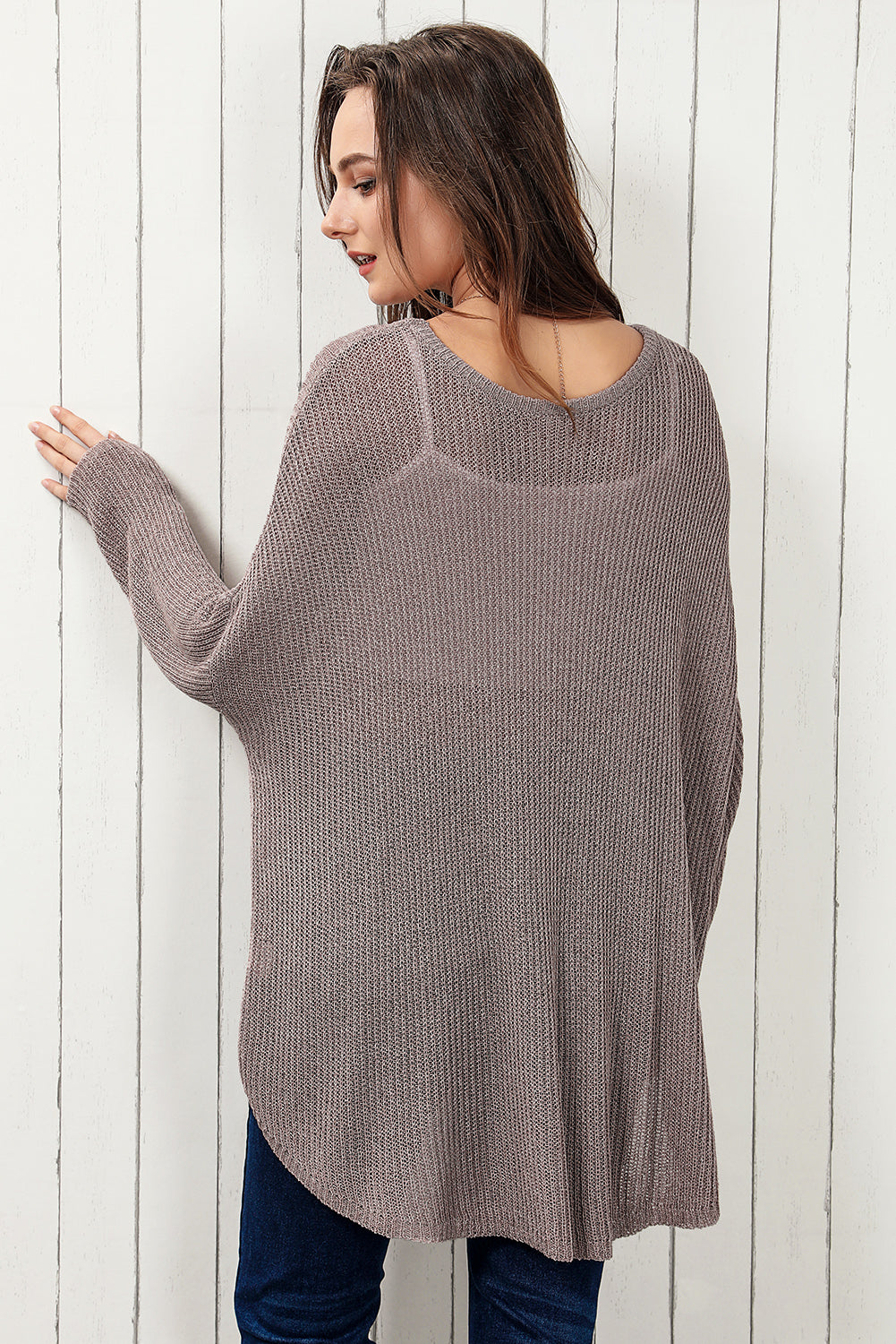Moss asymmetric slouch knit top with a relaxed fit and curved hem.