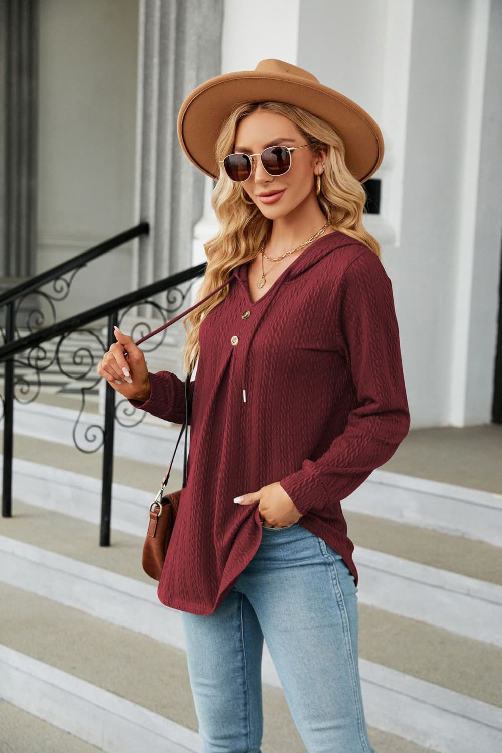 Textured henley hooded tunic in wine with drawstring and button detail.