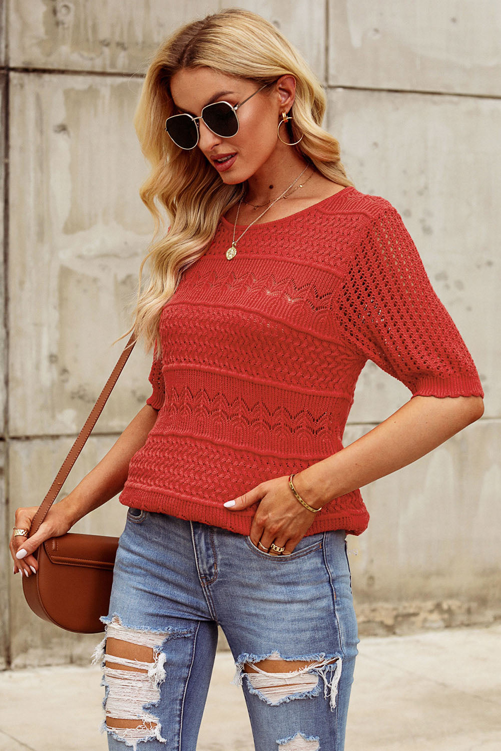 Rust openwork knit tee with short sleeves and a round neckline.