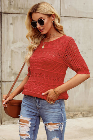 Rust openwork knit tee with short sleeves and a round neckline.