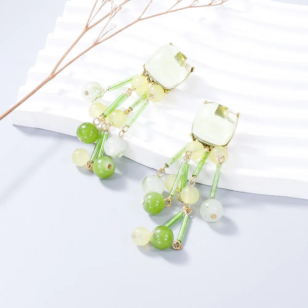 Beaded cascade statement earrings in Gum Leaf green and yellow acrylic and alloy with gold accents.