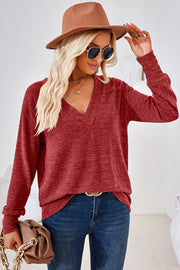 Relaxed V-neck tunic top in rust heather with long sleeves and a slouchy fit.