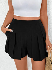 Black pleated shorts with pockets, featuring a textured fabric and a high-waisted fit.
