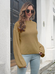 Camel batwing sleeve knit pullover sweater with ribbed texture and crew neck.