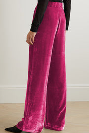 Velvet palazzo trousers in hot pink with a high waist and wide leg.