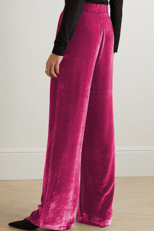 Velvet palazzo trousers in hot pink with a high waist and wide leg.