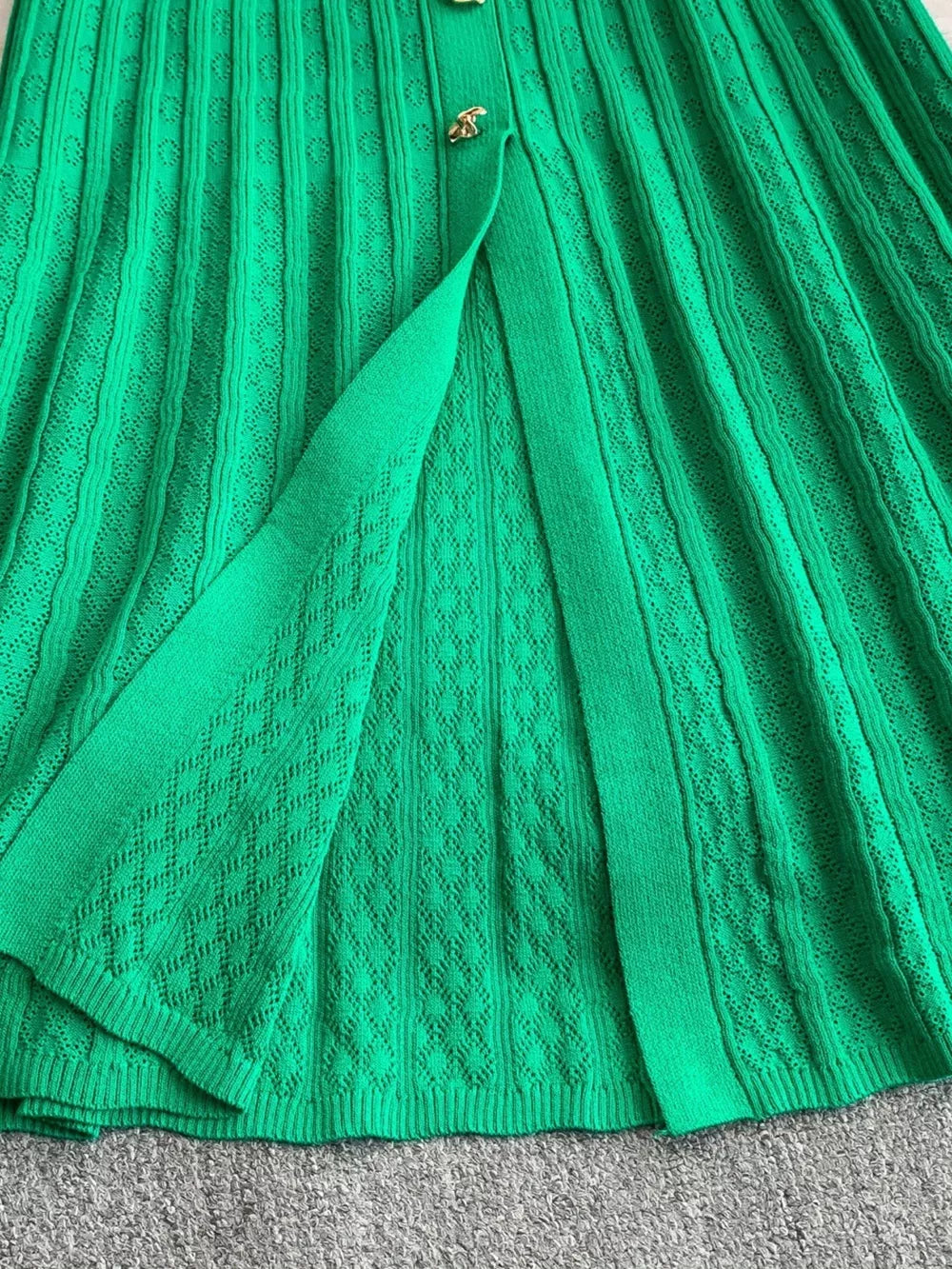 Green ribbed knit midi dress with button detail and open front slit.