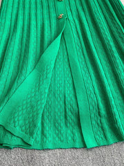 Green ribbed knit midi dress with button detail and open front slit.