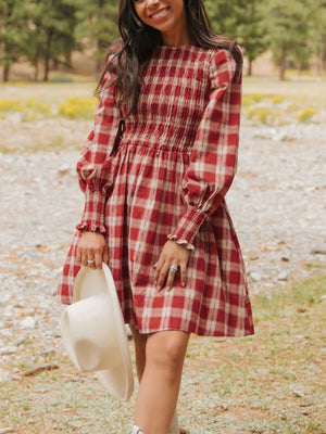 Red plaid cotton mini dress with smocked bodice and puff sleeves.