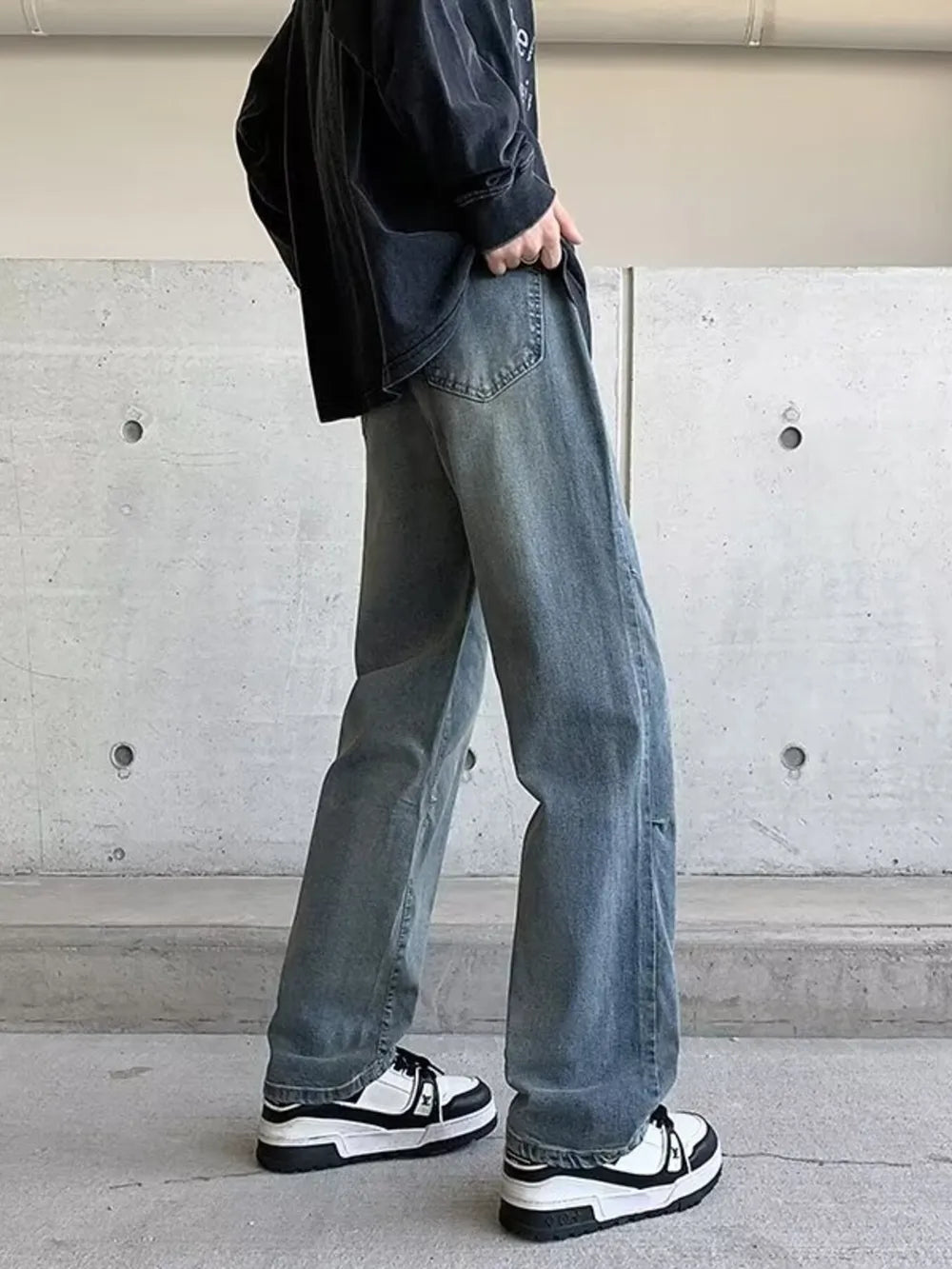 Men's vintage wash wide-leg jeans in light blue denim, relaxed fit.