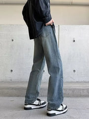 Men's vintage wash wide-leg jeans in light blue denim, relaxed fit.