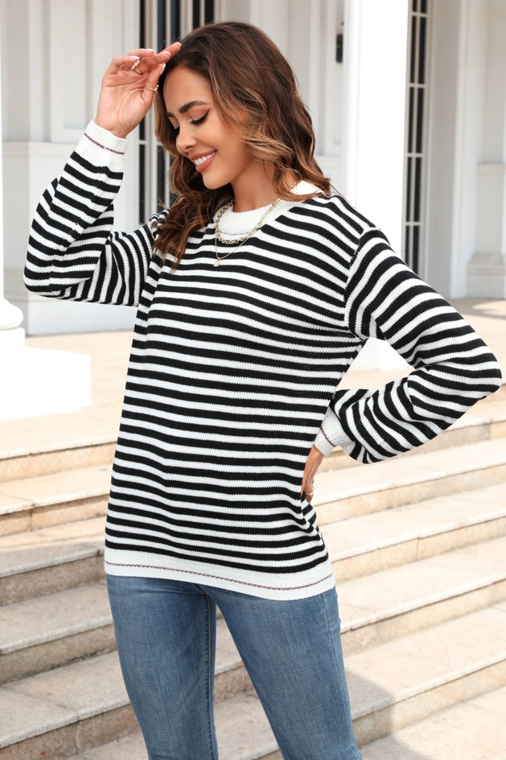 Black and white striped crewneck sweater with crew neckline and long sleeves.