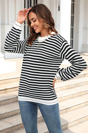 Black and white striped crewneck sweater with crew neckline and long sleeves.