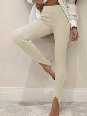 Cream ribbed knit stirrup leggings with a high waist and split ankle detail.