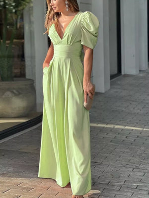 Lime green romper with puff sleeves, deep V-neck, cinched waist, and wide legs.