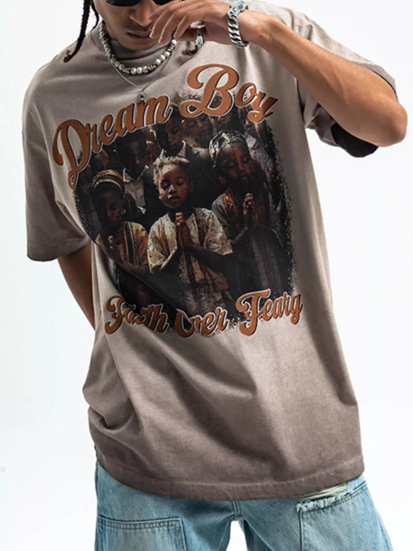 Khaki graphic t-shirt with puff sleeves and a "Dream Boy Faith Over Fear" print.