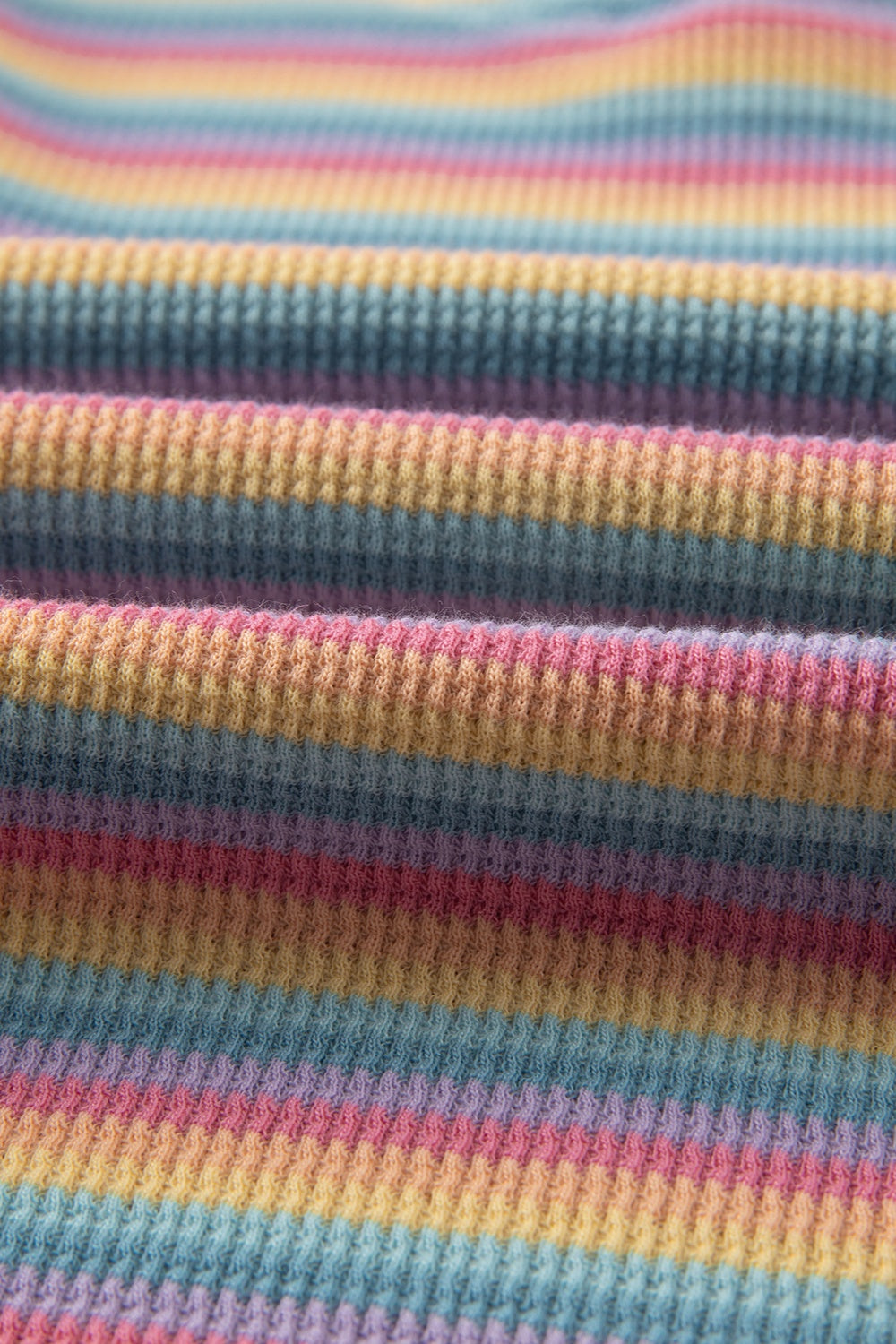 Rainbow stripe lounge set fabric detail, soft cotton waffle knit with pastel stripes.