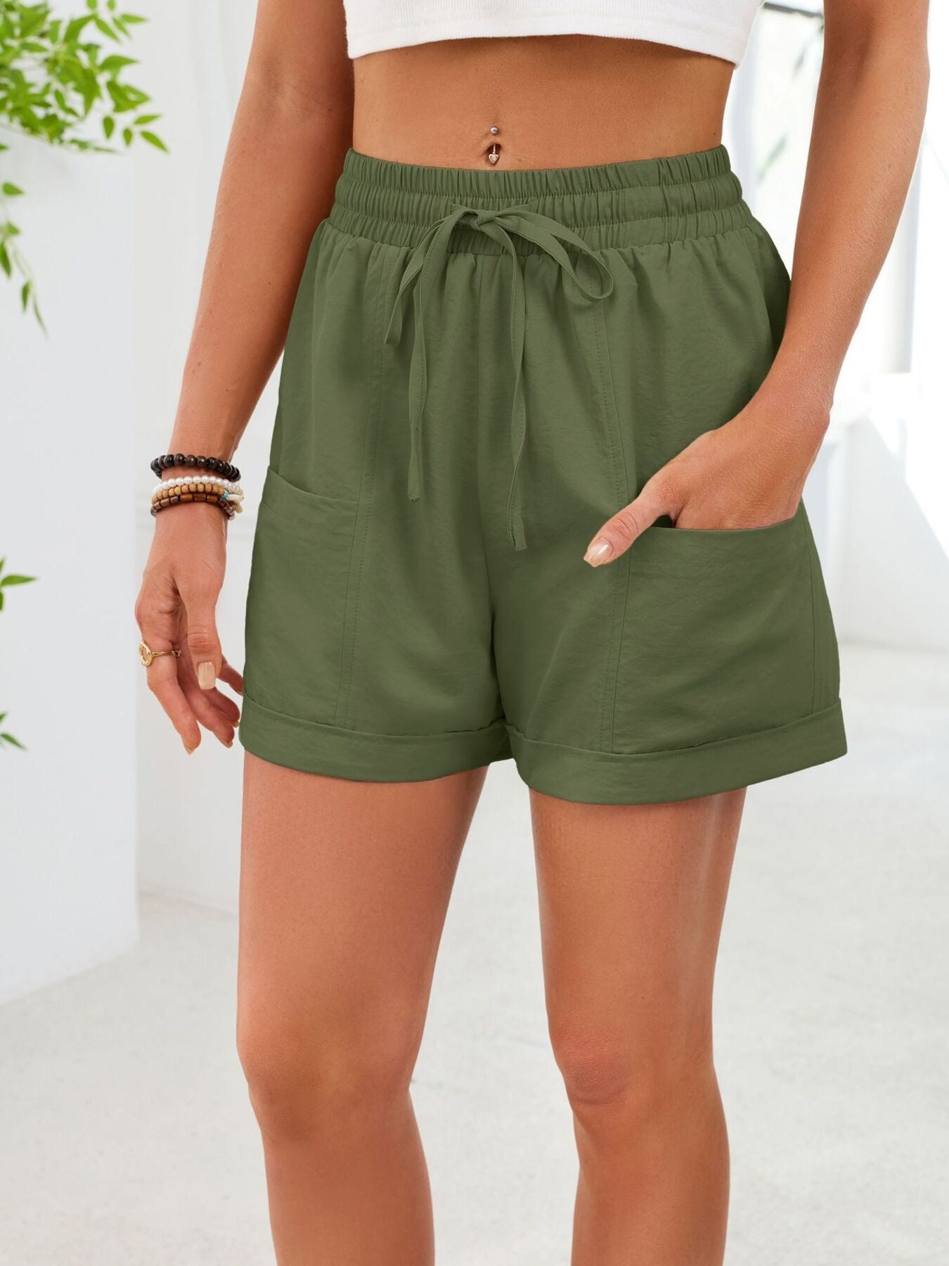 Army green casual shorts with elastic waist, drawstring, and pockets.