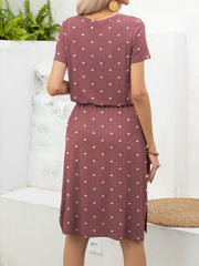 Drawstring waist midi dress in Moonlit Mauve with white polka dots, short sleeves, and a relaxed A-line cut.