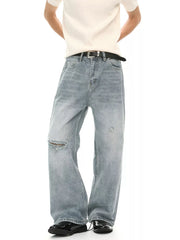Light wash distressed denim wide-leg jeans with a ripped knee detail.